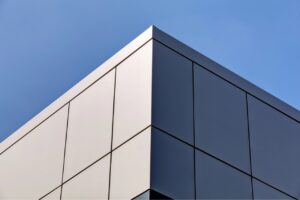 Exterior wall cladding with metal, wood, brick and mortar, and vinyl finishes
